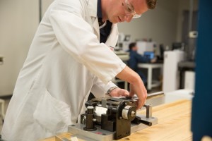Novelis engineer conducts bend test on an aluminum alloy sample to ensure it meets customer requirements